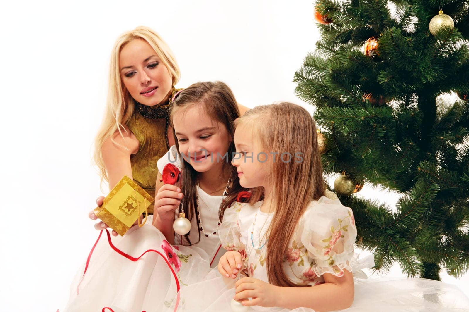 Beautiful mother makes a present to her children in christmas