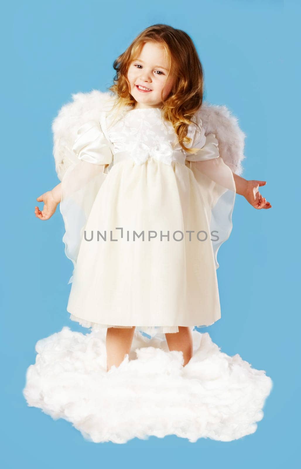 Portrait of cute little cupid standing on cloud