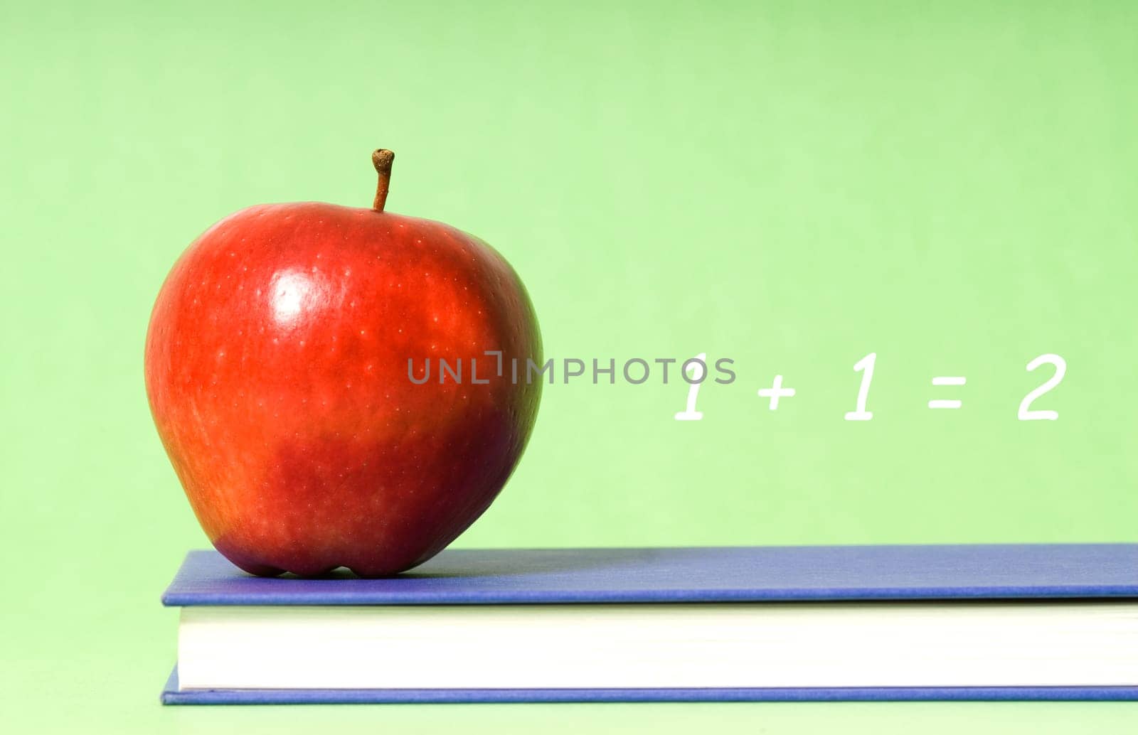 apple on green background on blue book