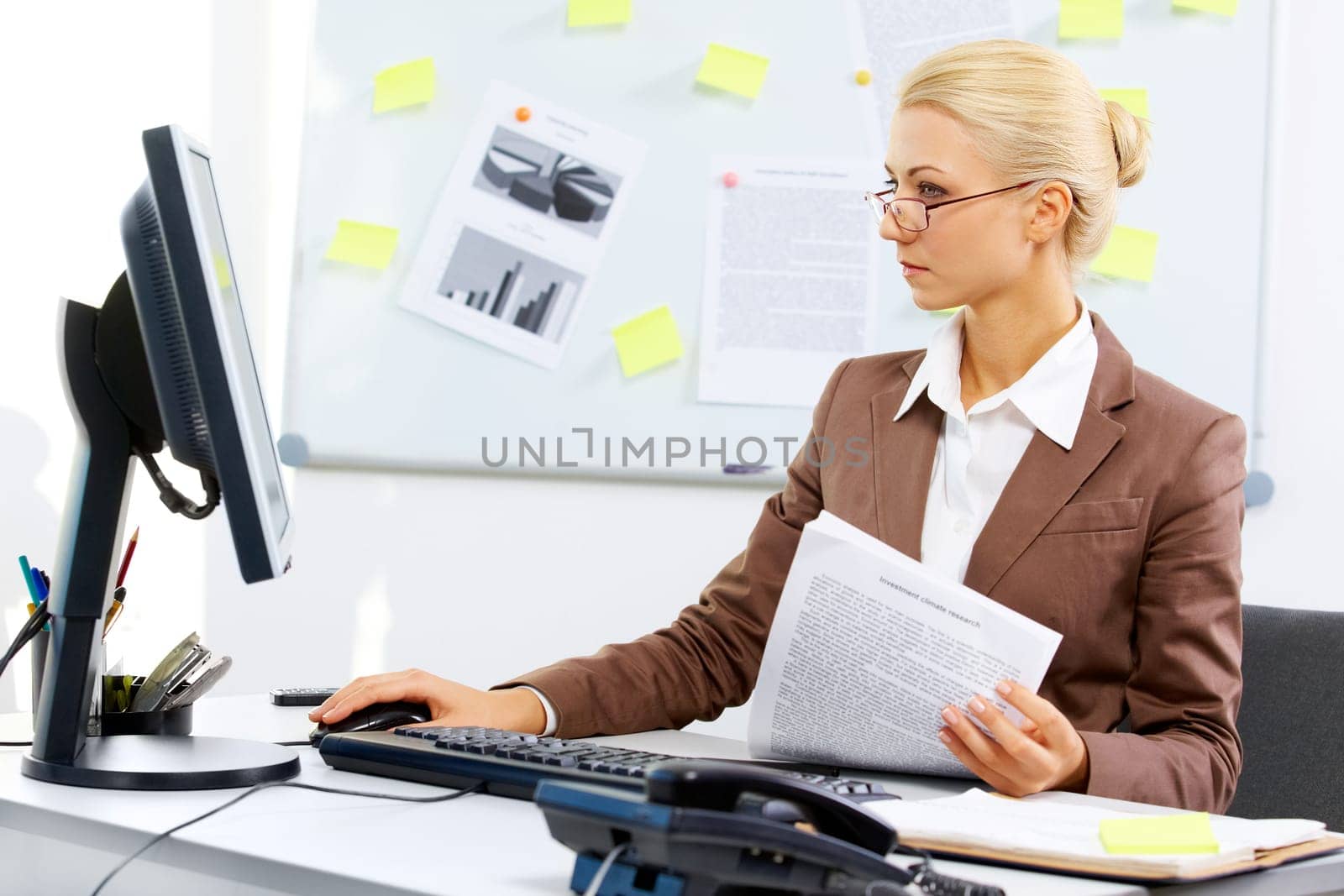 A young businesswoman looking at the monitor screen