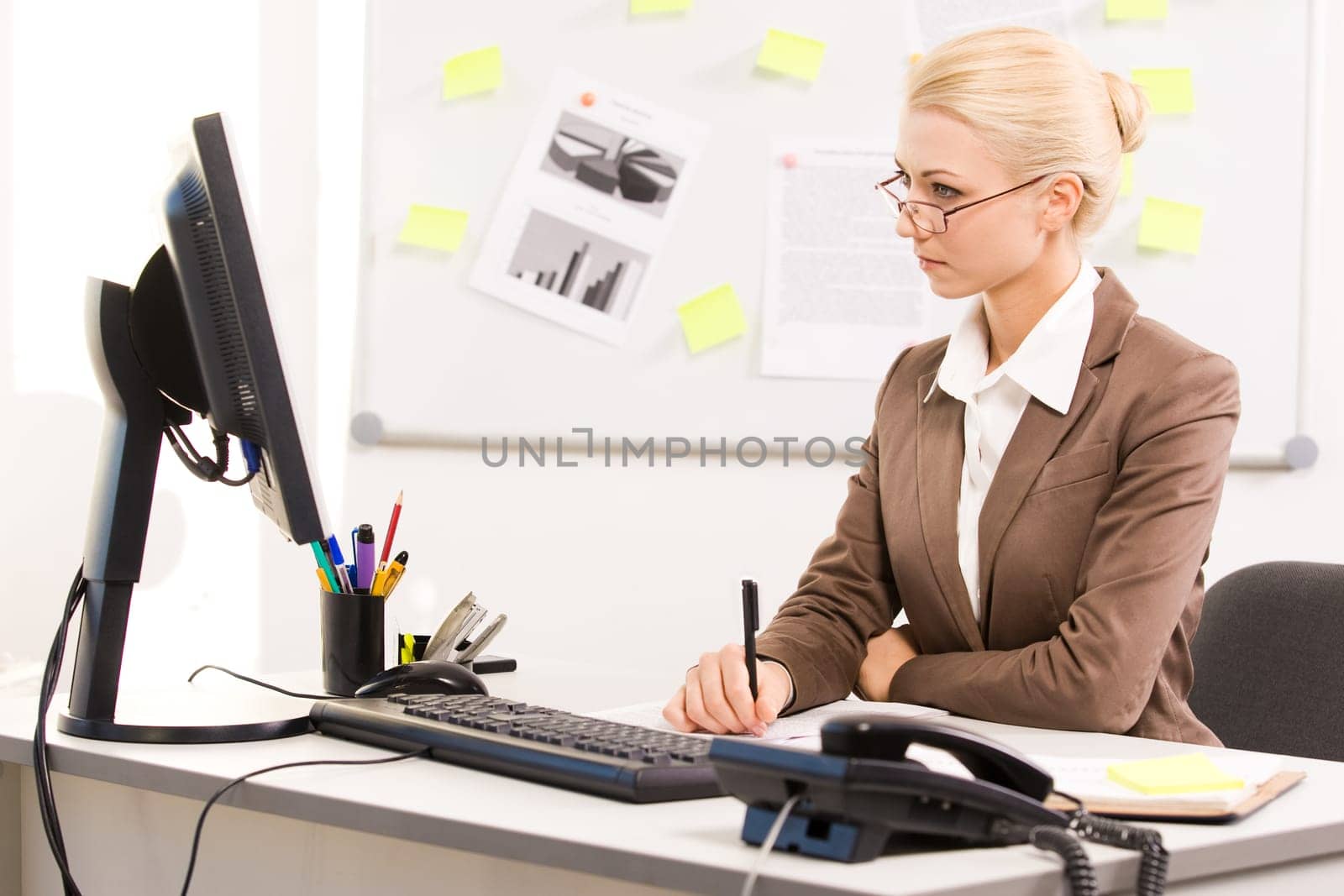 Image of executive lady sitting before computer in office and working