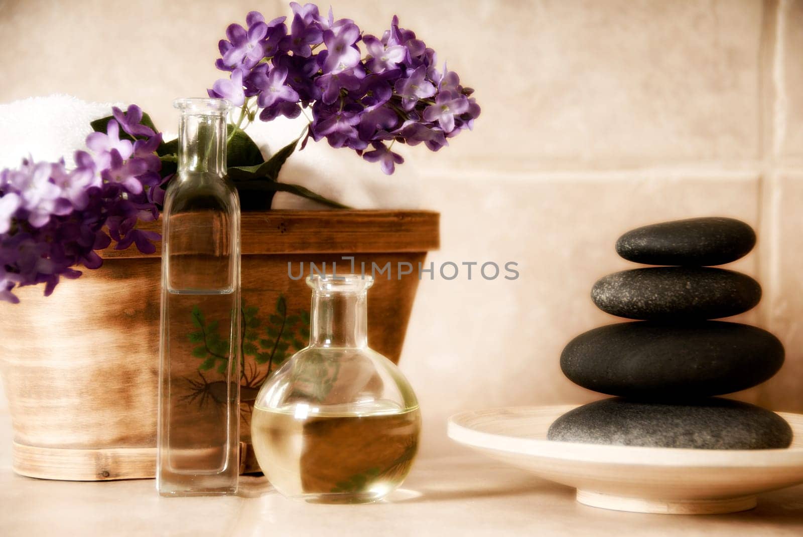 day spa products with stones, oil container, flowers