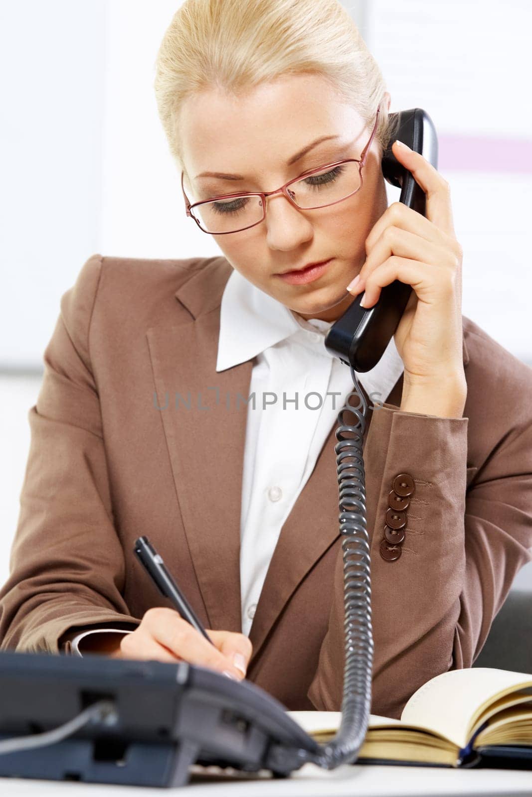 Portrait of a young beautiful businesswoman talking on the phone