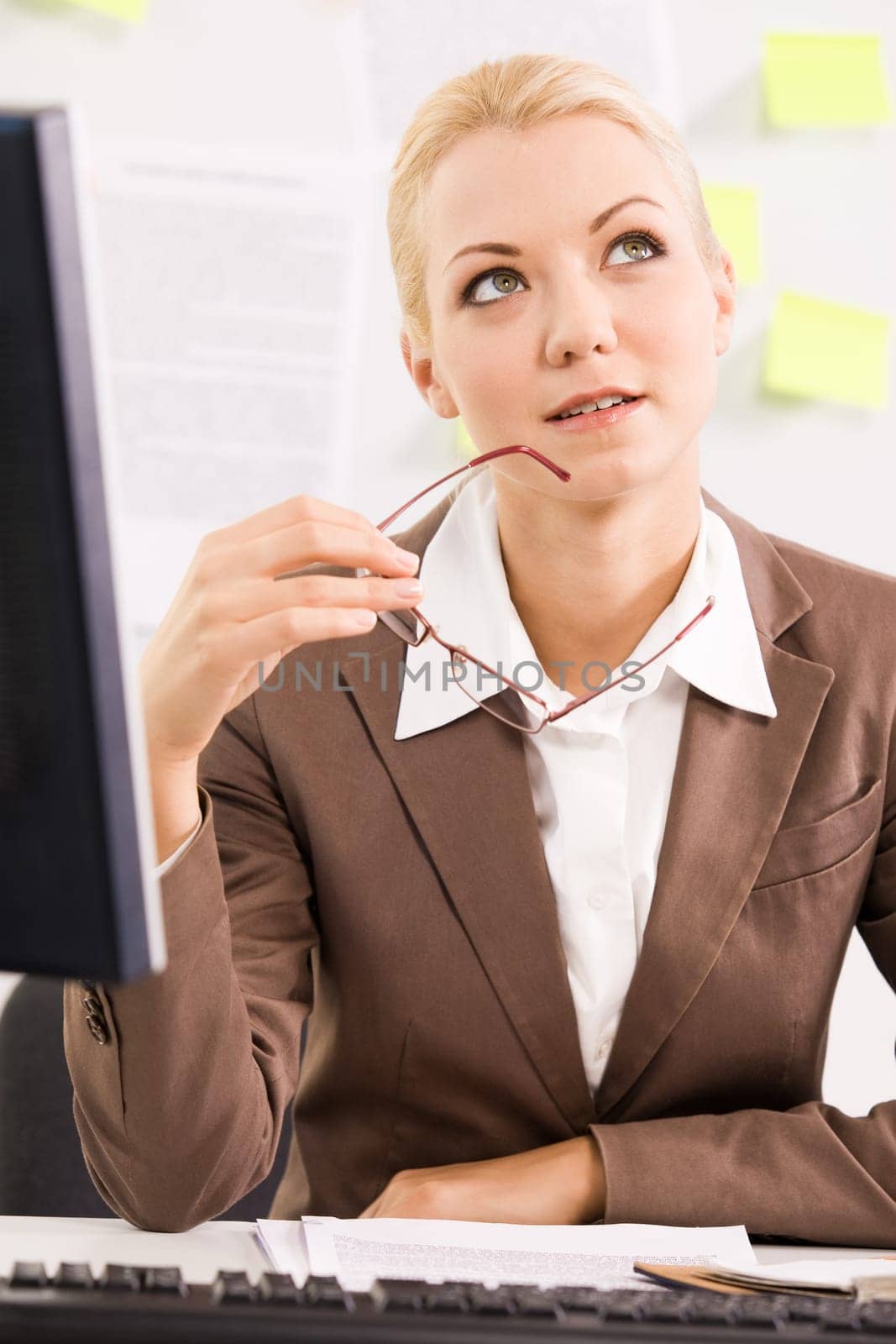 Portrait of pensive businesswoman sitting at workplace