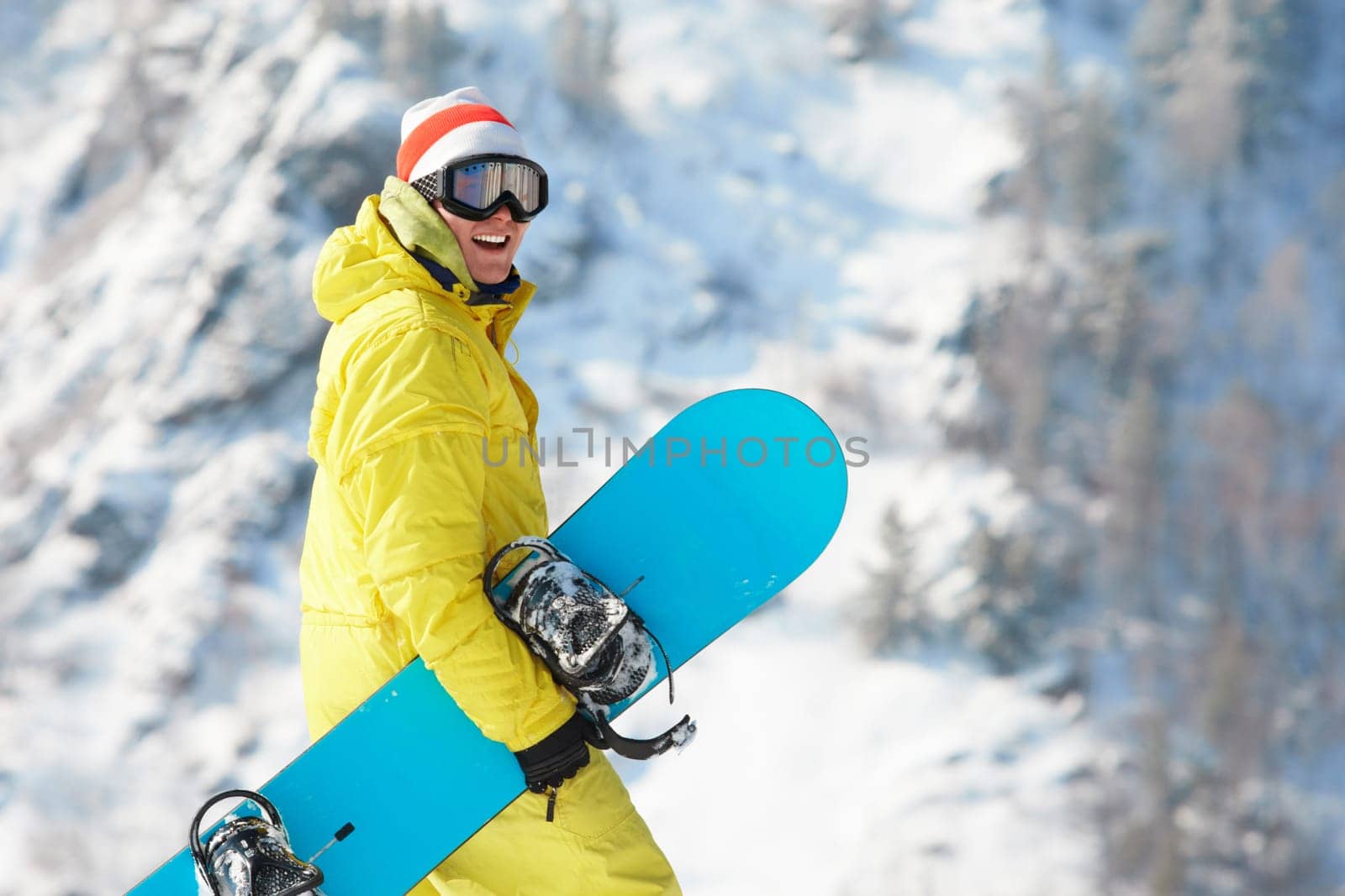 View of sportsman with snowboard standing in the forest