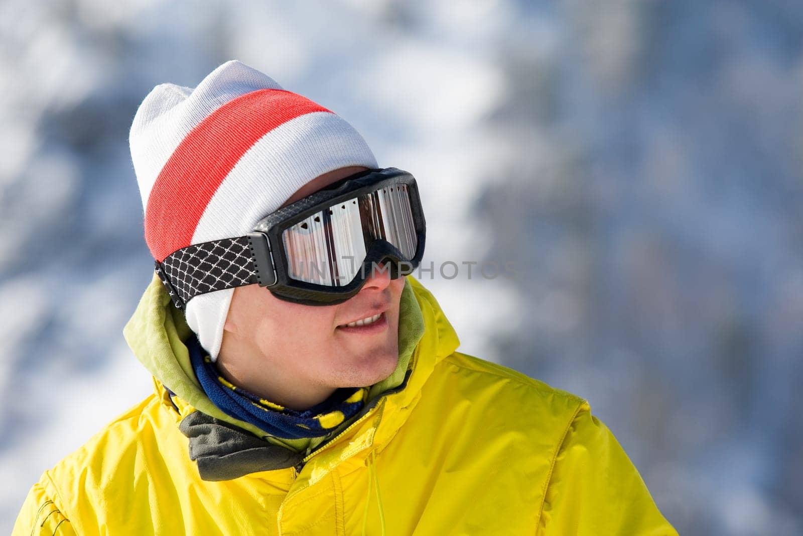 Portrait of happy young man looking through eyeglasses and smiling