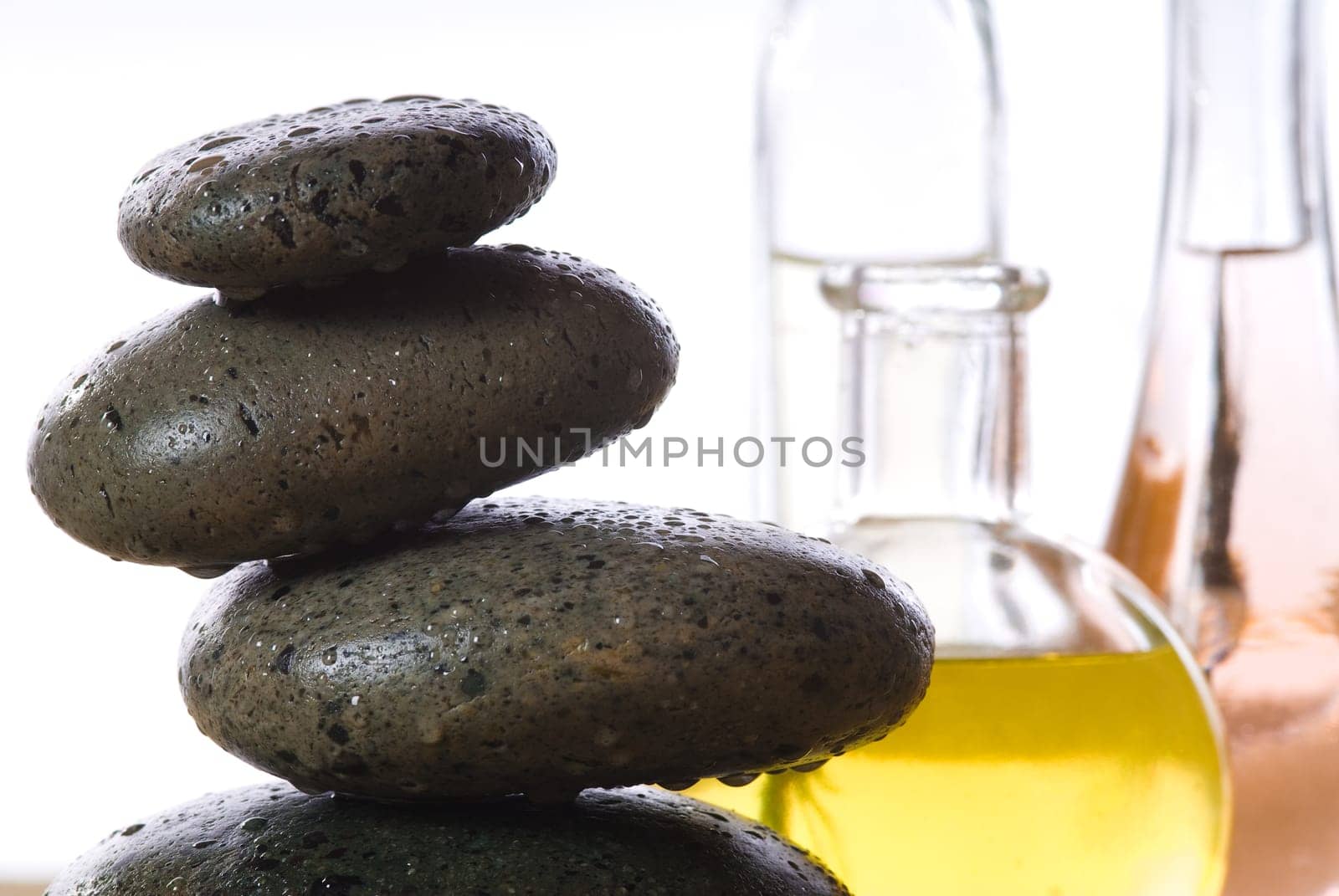 spa products with stones massage flasks and oil