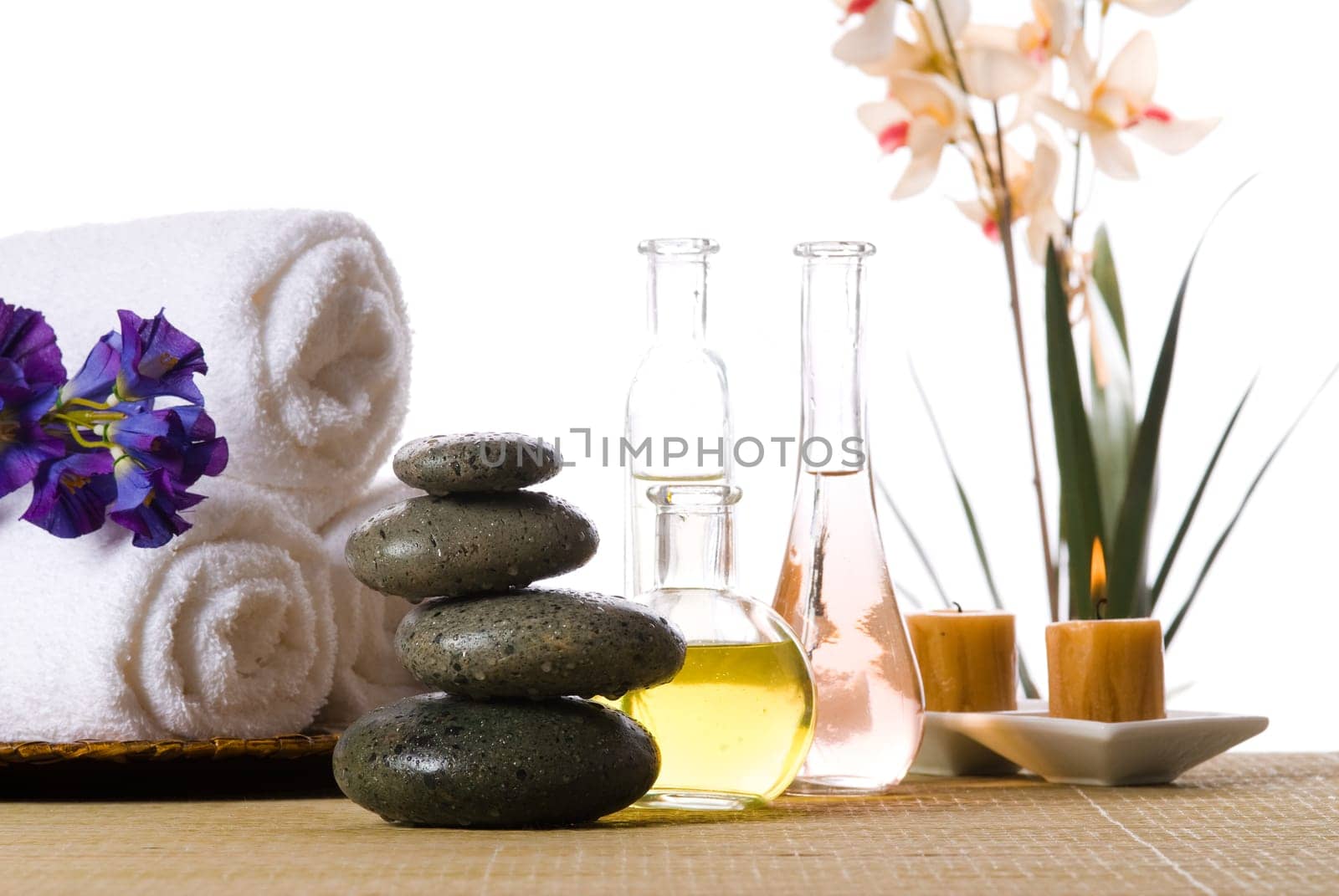 spa products with stones towels flasks and oil
