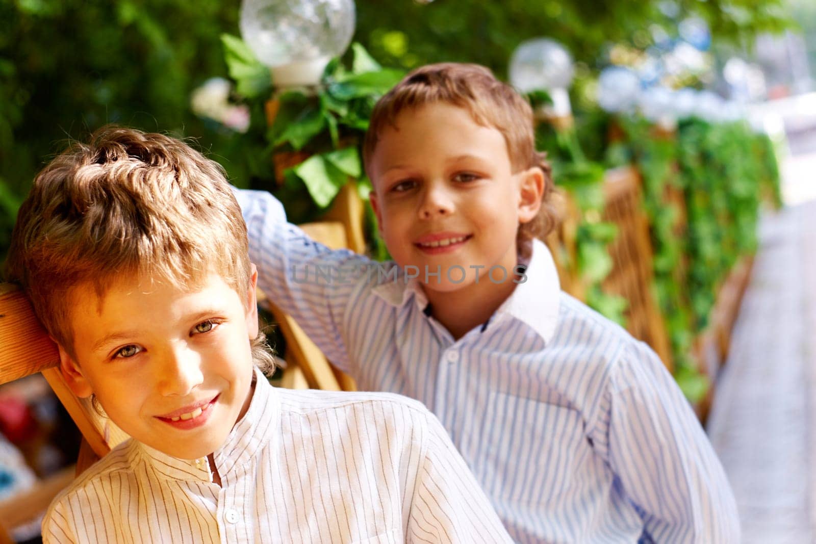 Portrait of happy kid looking at camera with his friend behind
