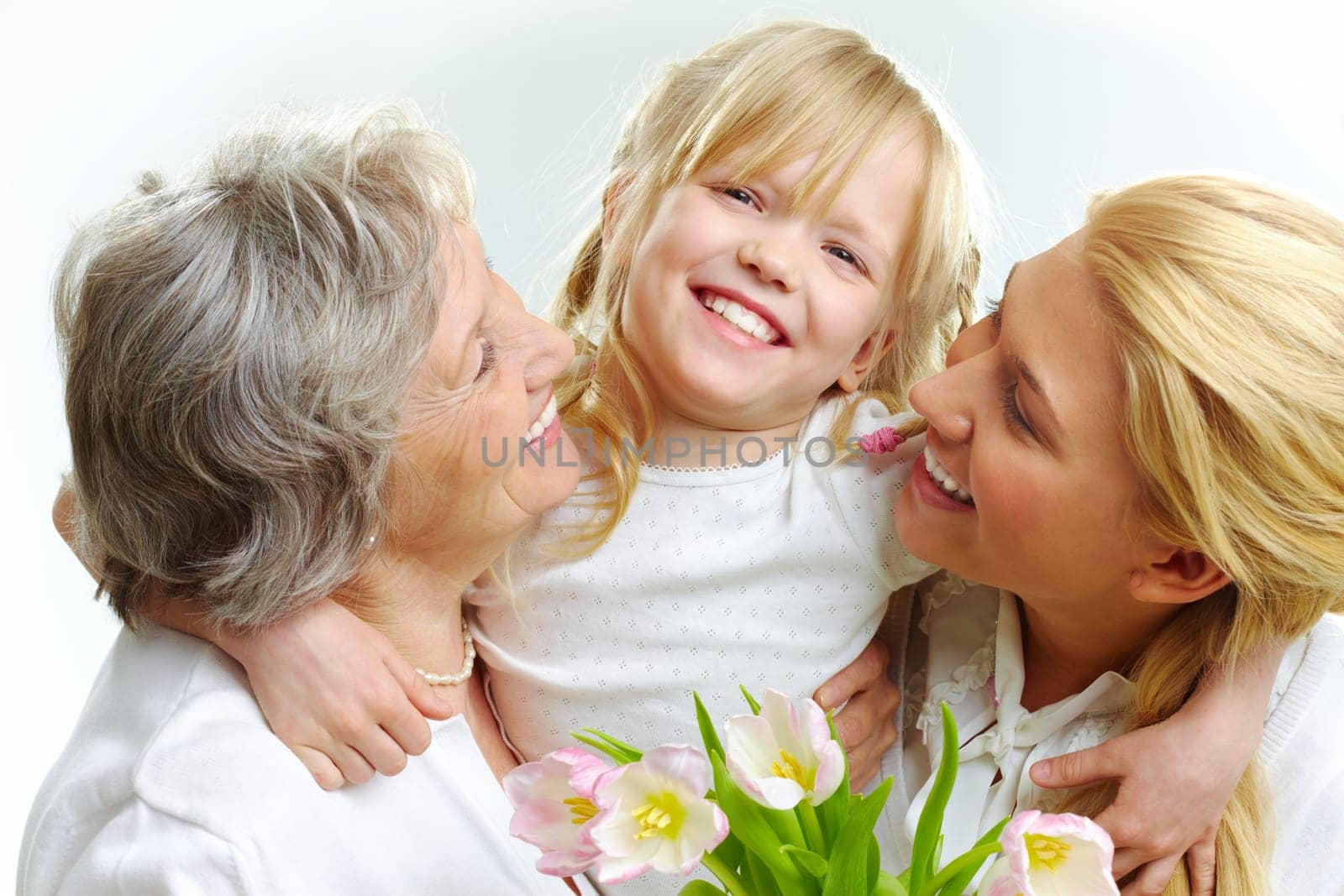 Portrait of happy girl hugging mature lady and woman