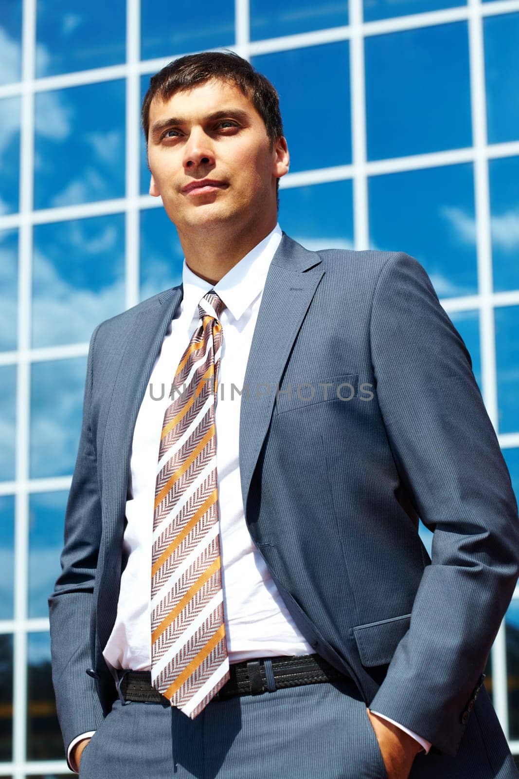Portrait of confident businessman on background of office building