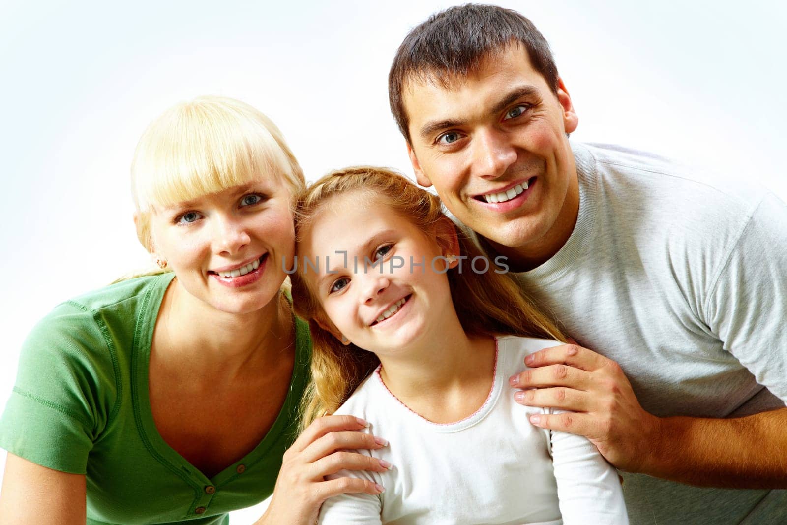 Portrait of happy family in casual clothes looking at camera