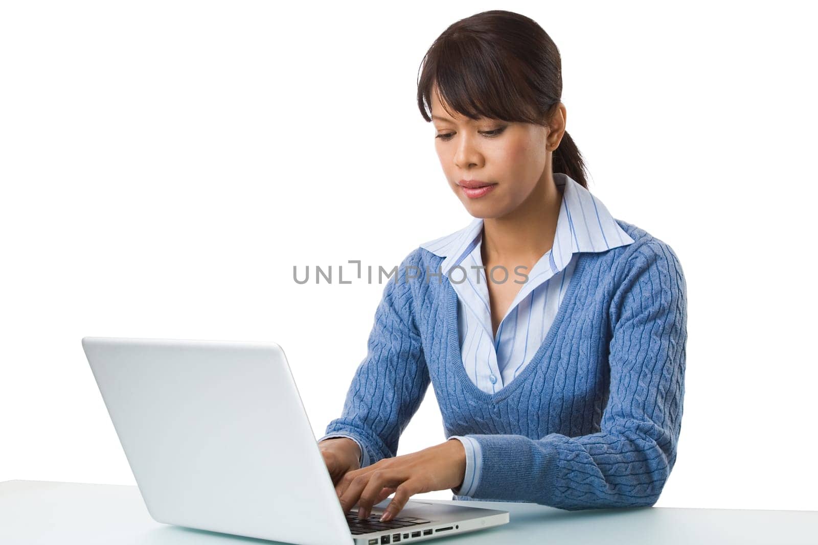 Image of young successful employer typing on laptop at workplace