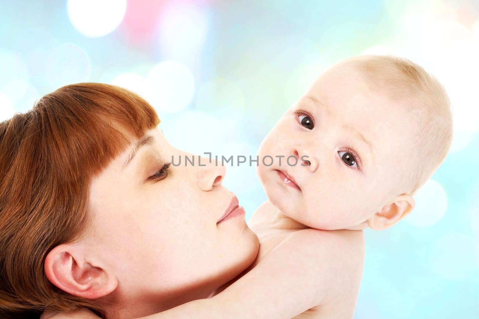 Close-up of careful mummy with her baby on white background