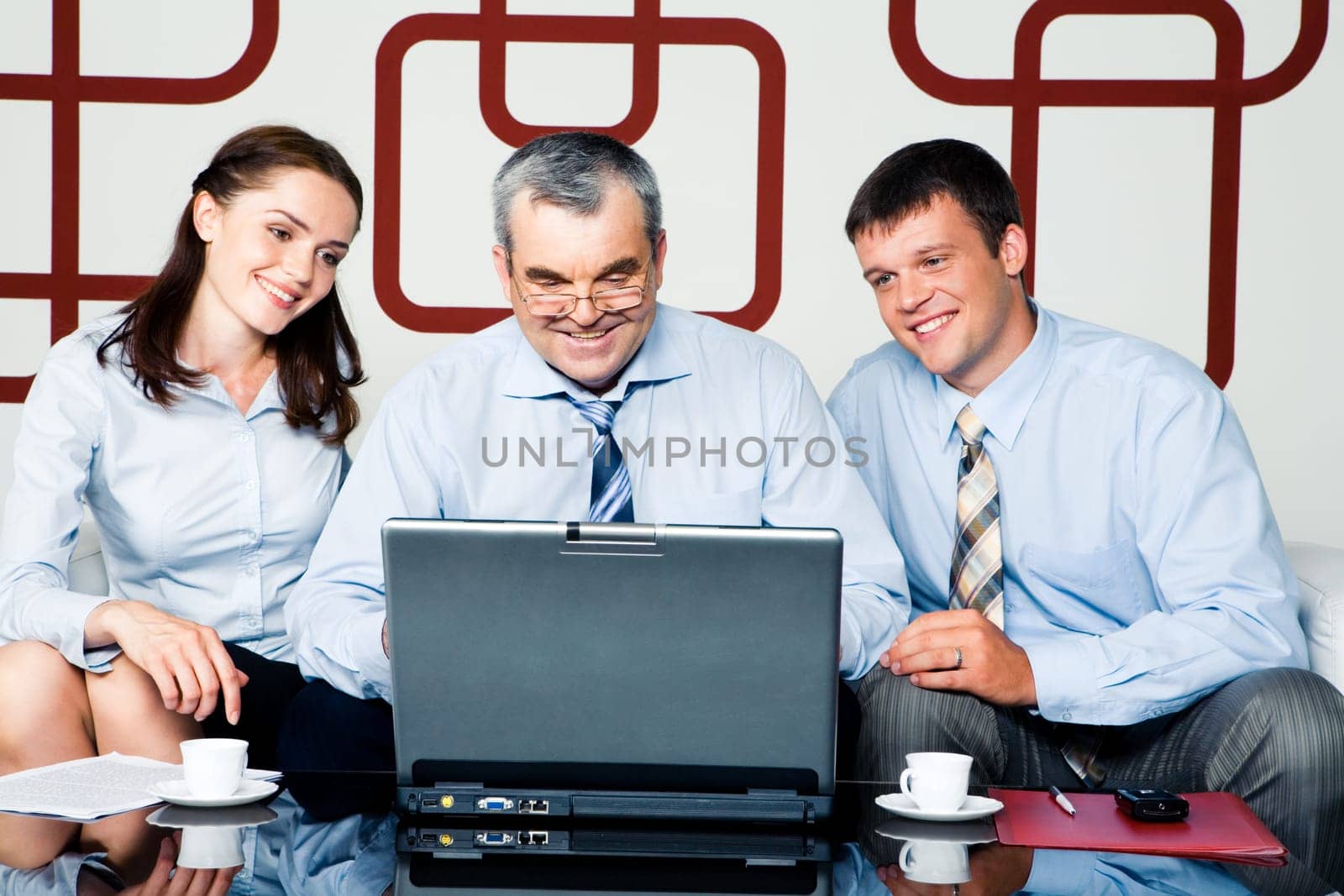 Image of businesspeople looking at monitor of laptop at meeting