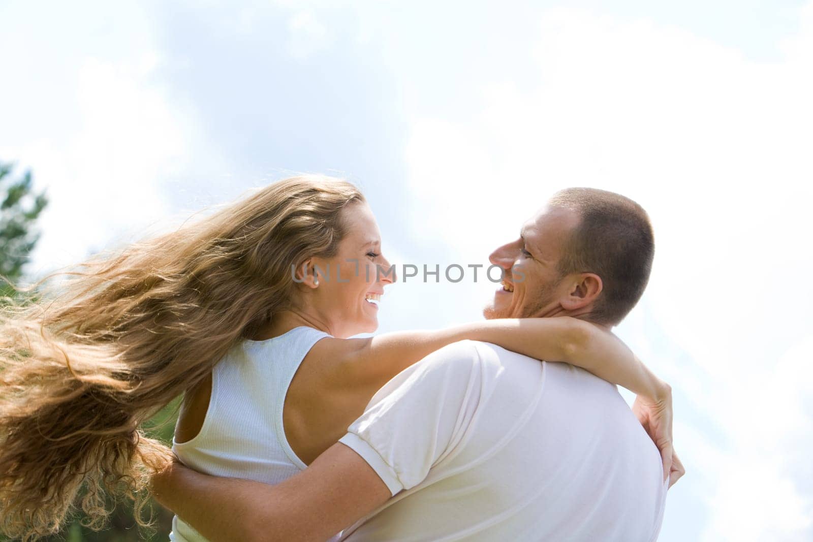 Happy male and female looking at each other and both laughing