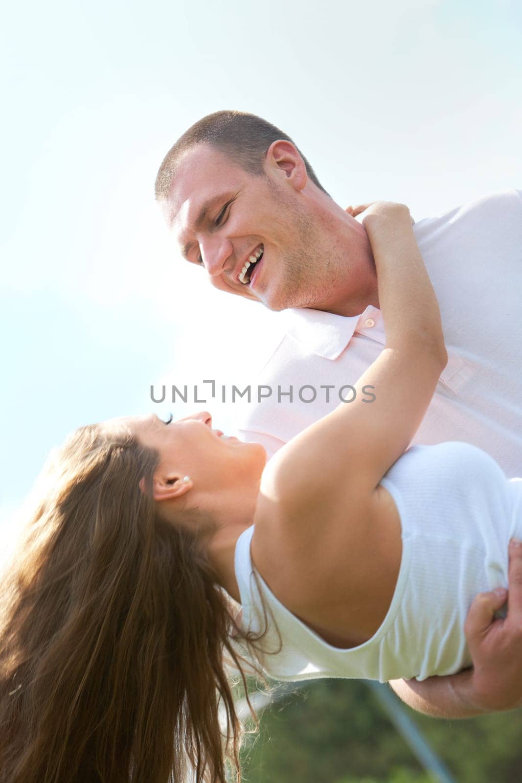 Happy male holding his girlfriend and both laughing