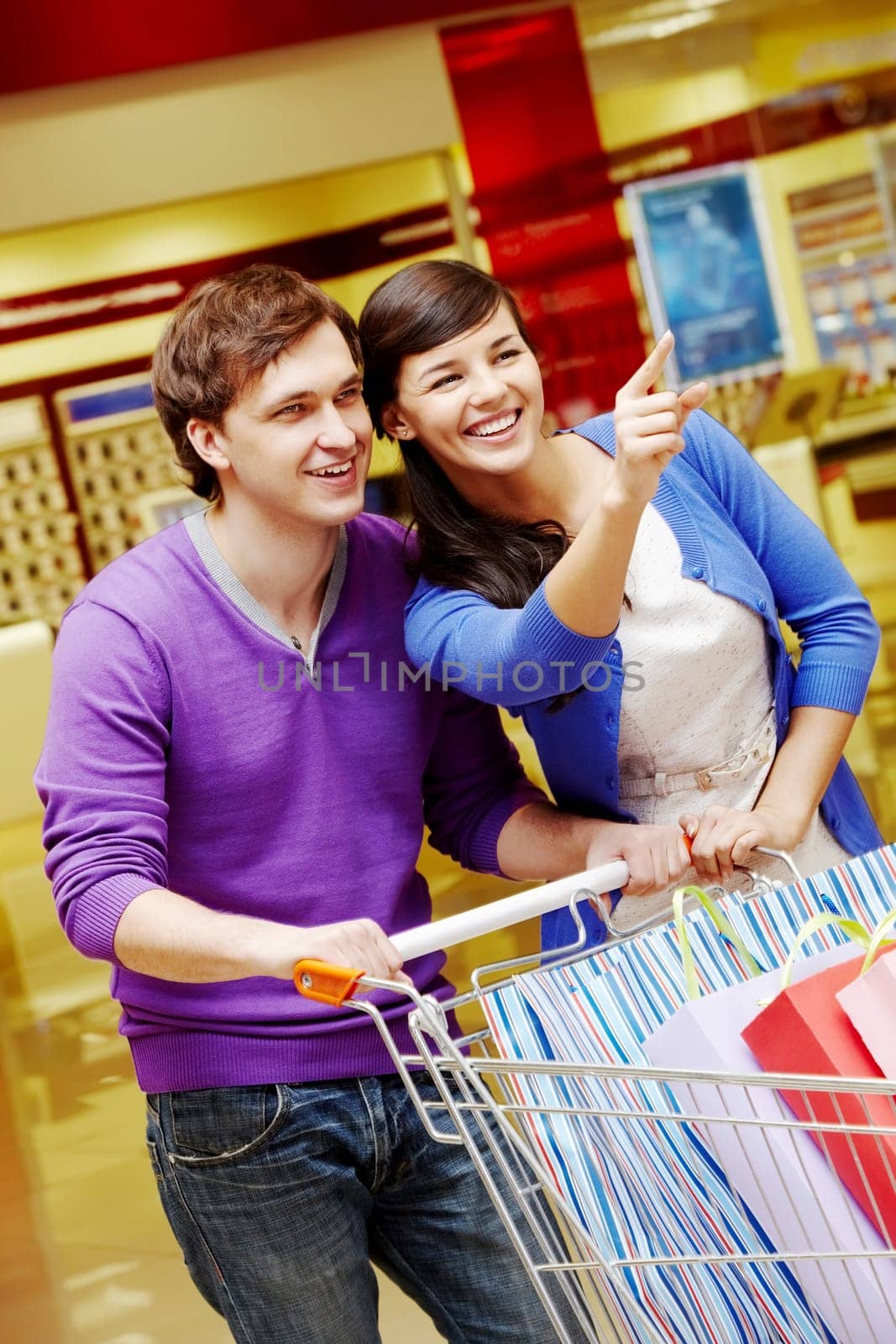 Portrait of two shopaholics during shopping in the mall