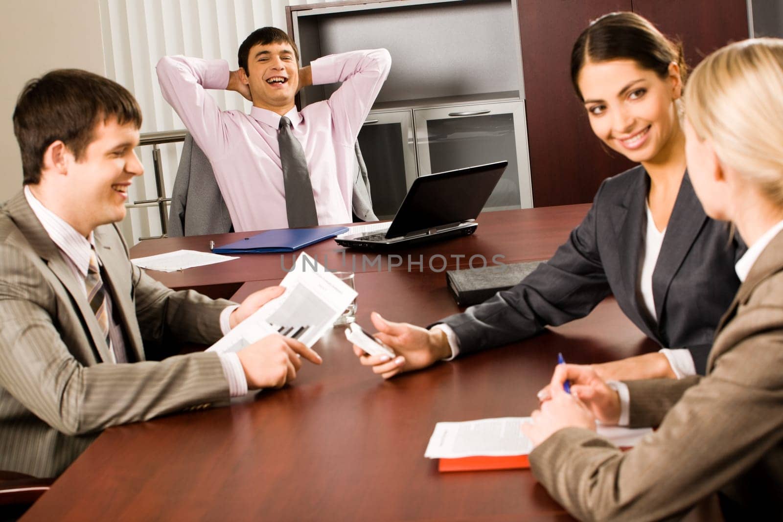 Office life: several business people sitting at the table