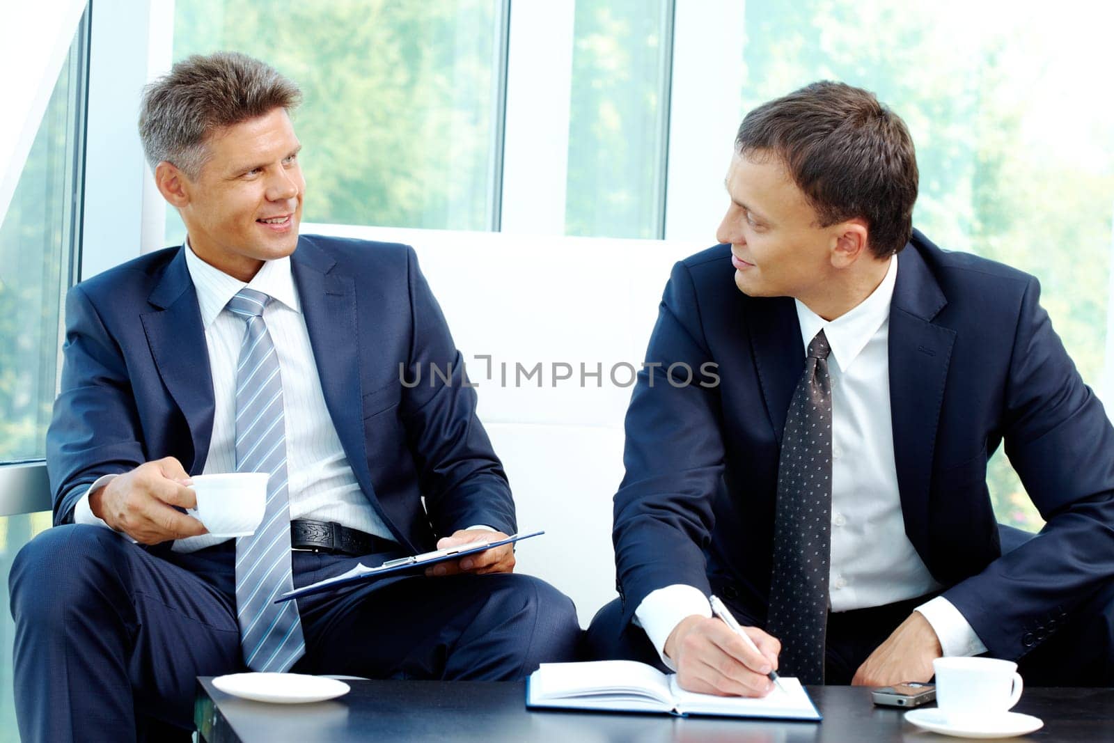Image of smart businessmen discussing new strategy at meeting
