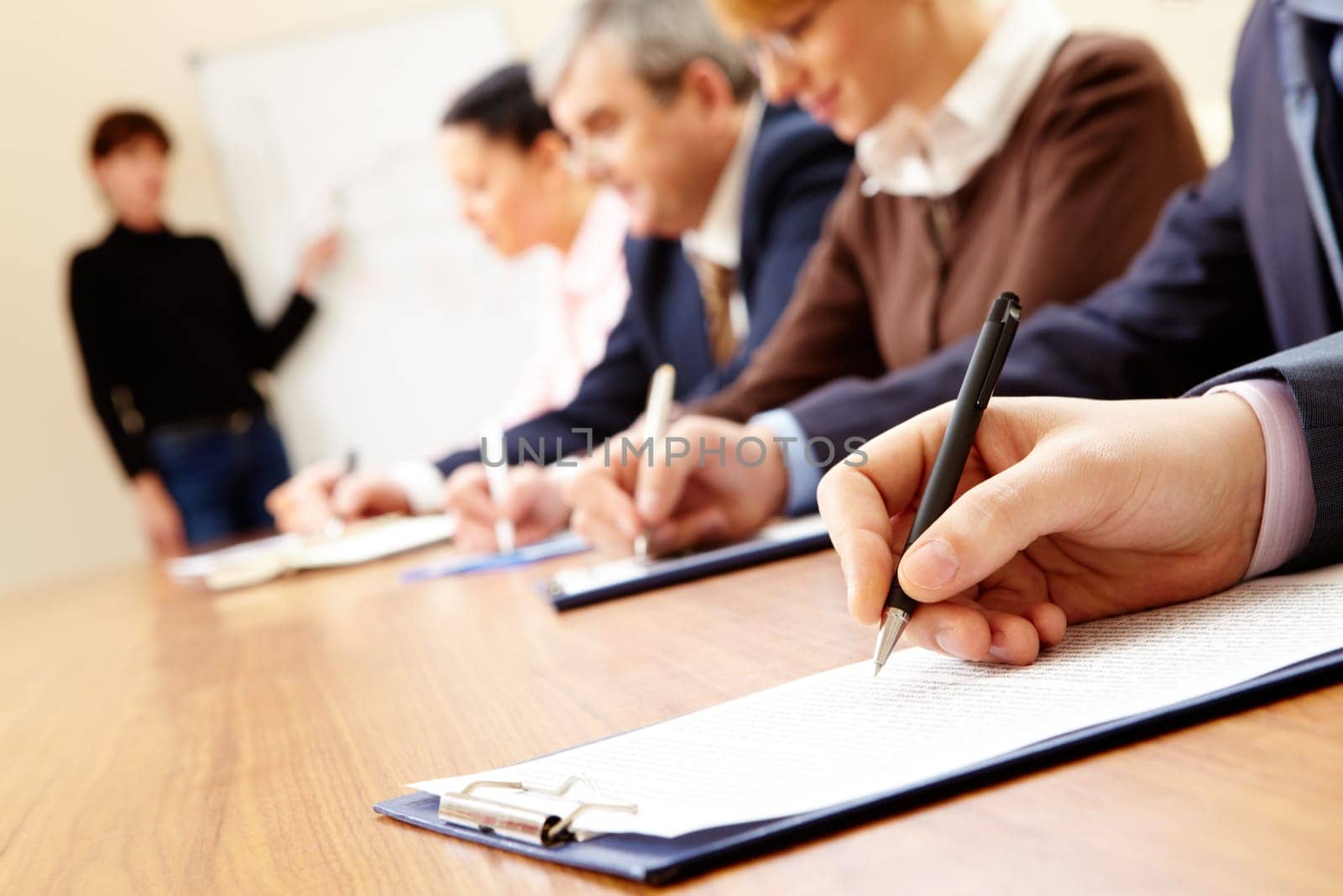 Close-up of business people writing text during business training