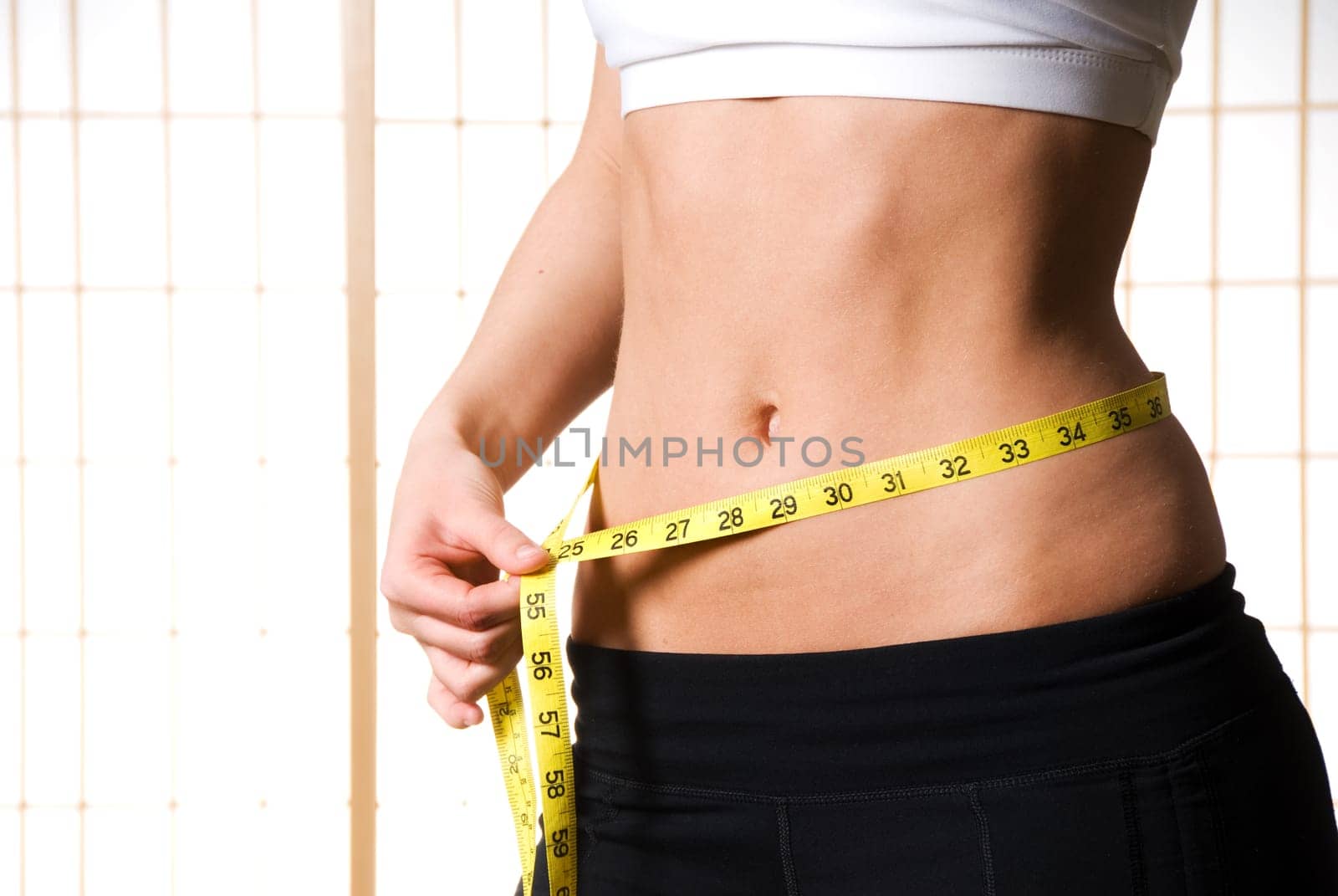 Woman with a tape measure at the waist