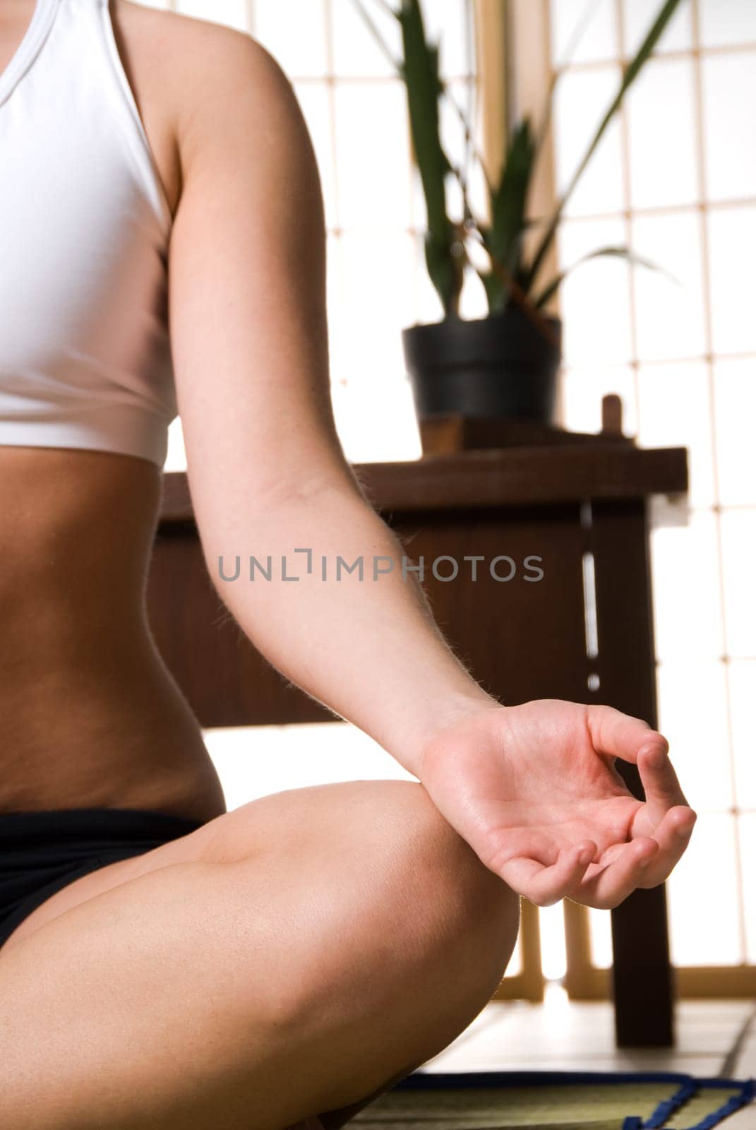 young blond woman meditating on the ground
