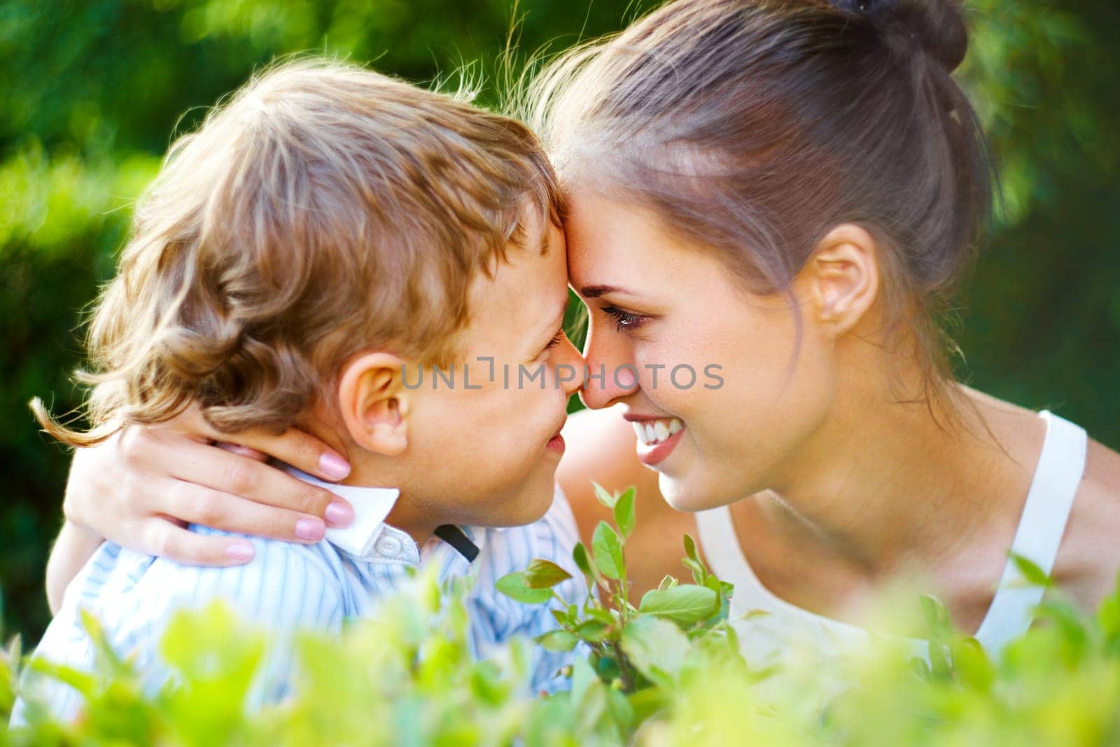 Portrait of handsome boy and his mother having fun