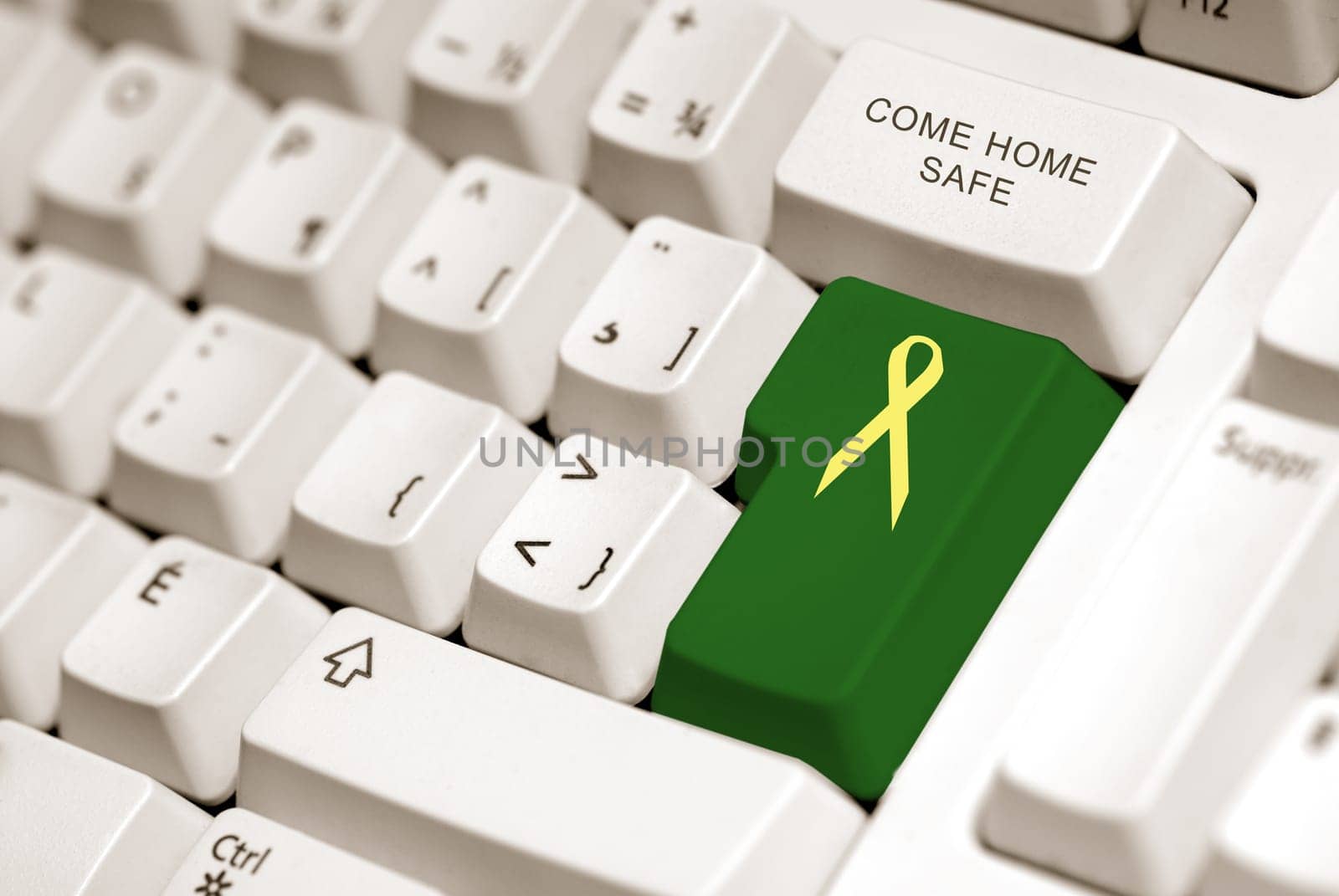 yellow ribbon on green button to sybolized troop support