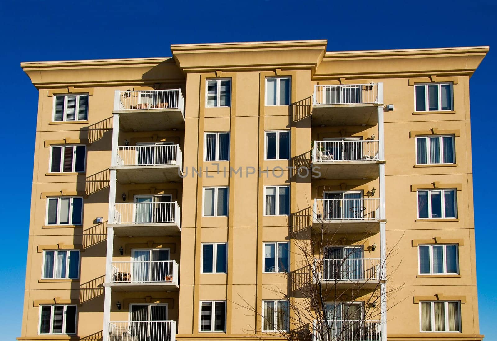 modern beige and brown apartment condos on blue sky