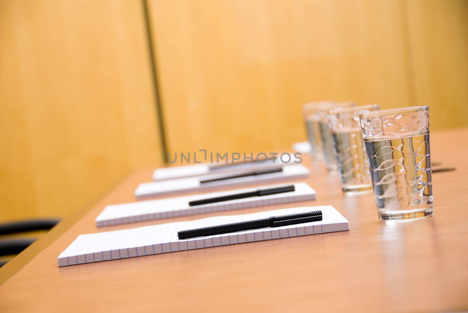 set boardroom with some water glasses and some paper