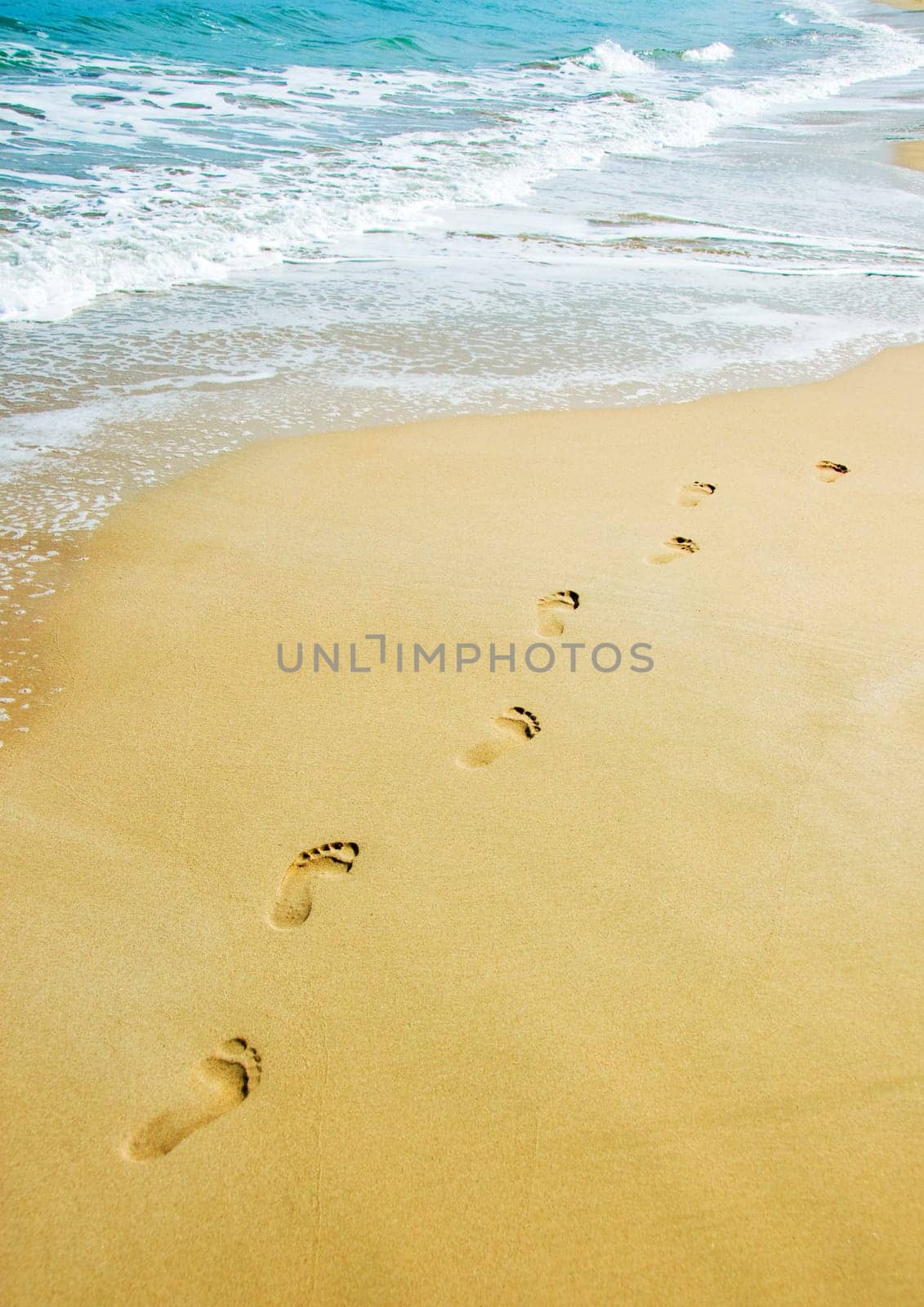 foot steps on the beach in the tropics