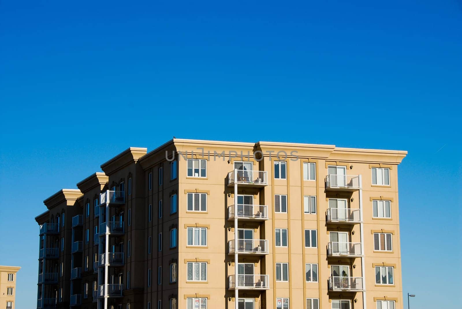 modern beige and brown apartment condos on blue sky