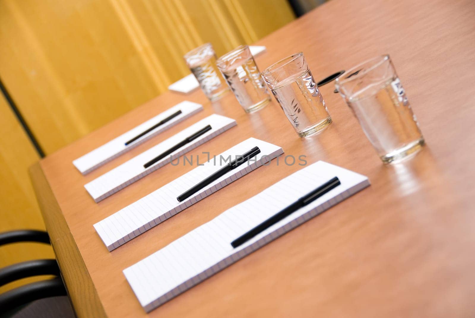 set boardroom with some water glasses and some paper