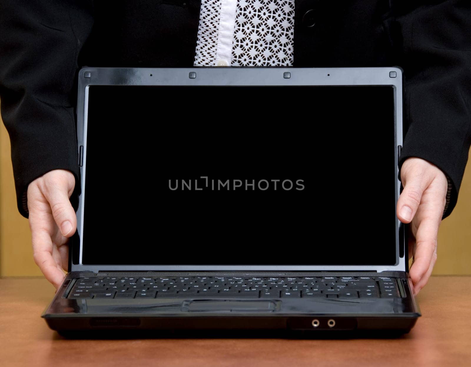 woman holding her laptop closeup on a desk