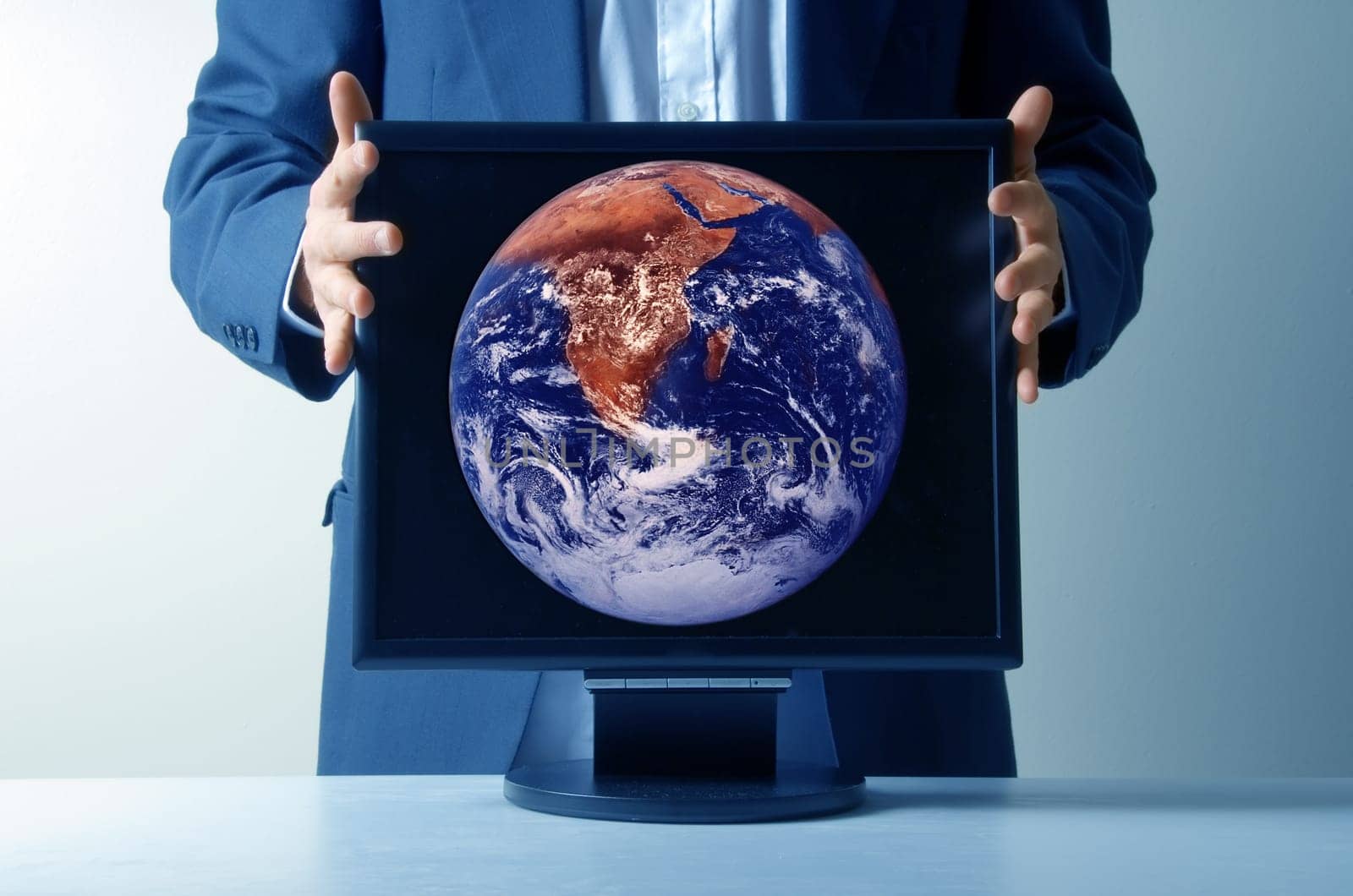 businessman holding an lcd monitor