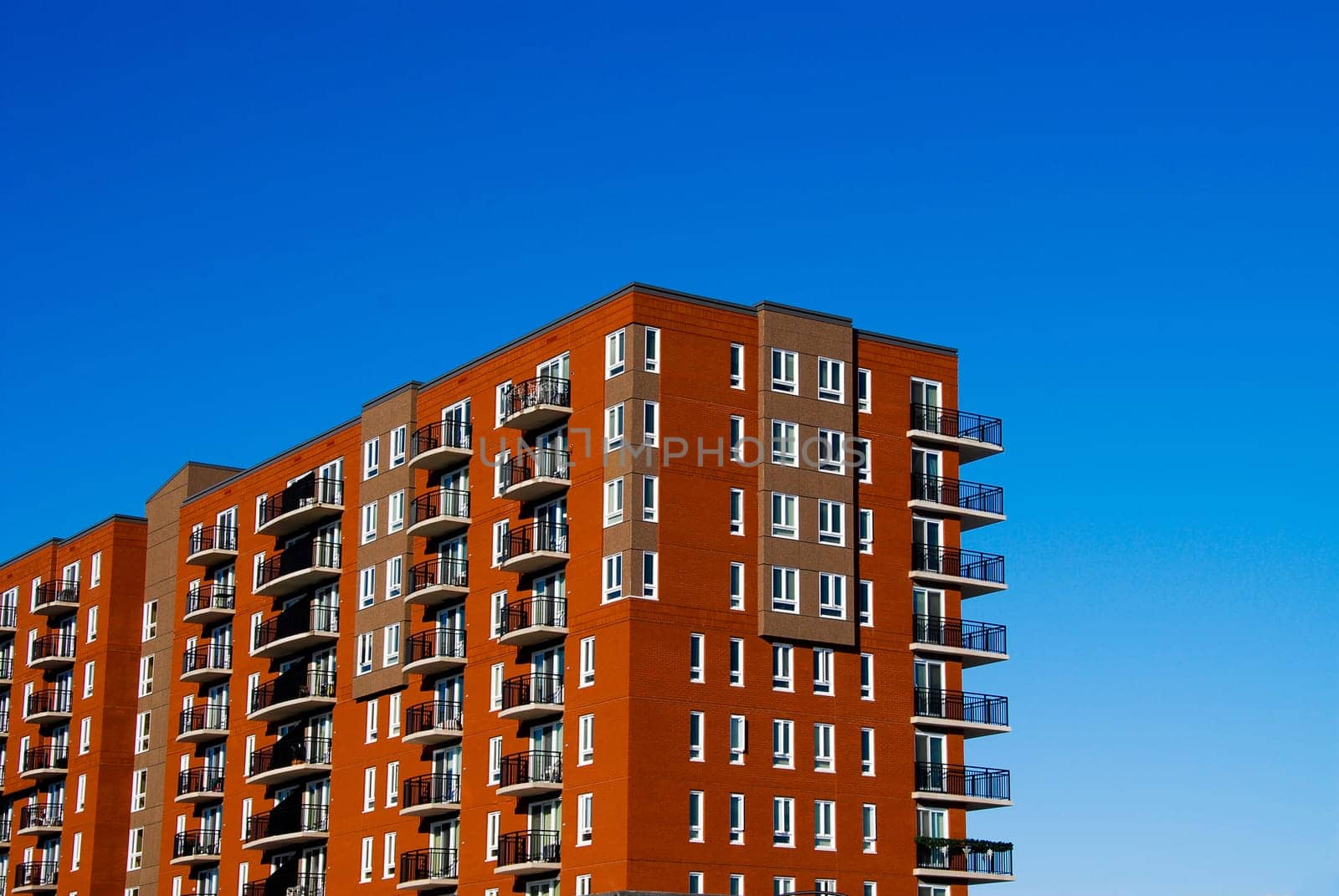 red brick condo complex on a blue sky