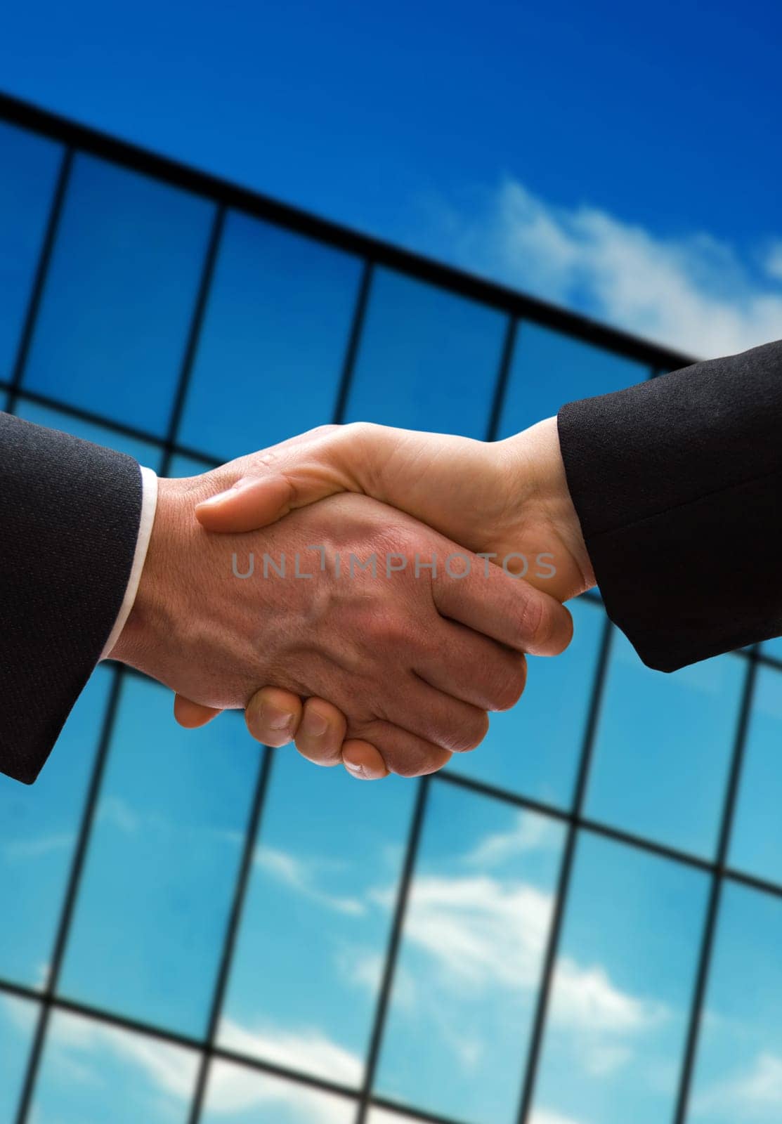 a business hand shake outside the office building
