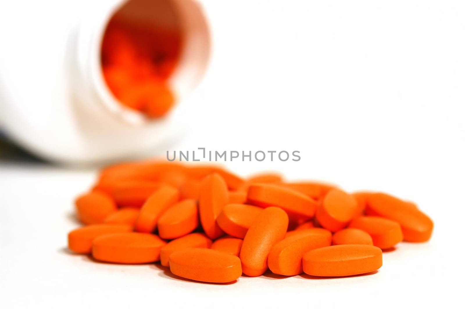 orange vitamin pills out of the bottle