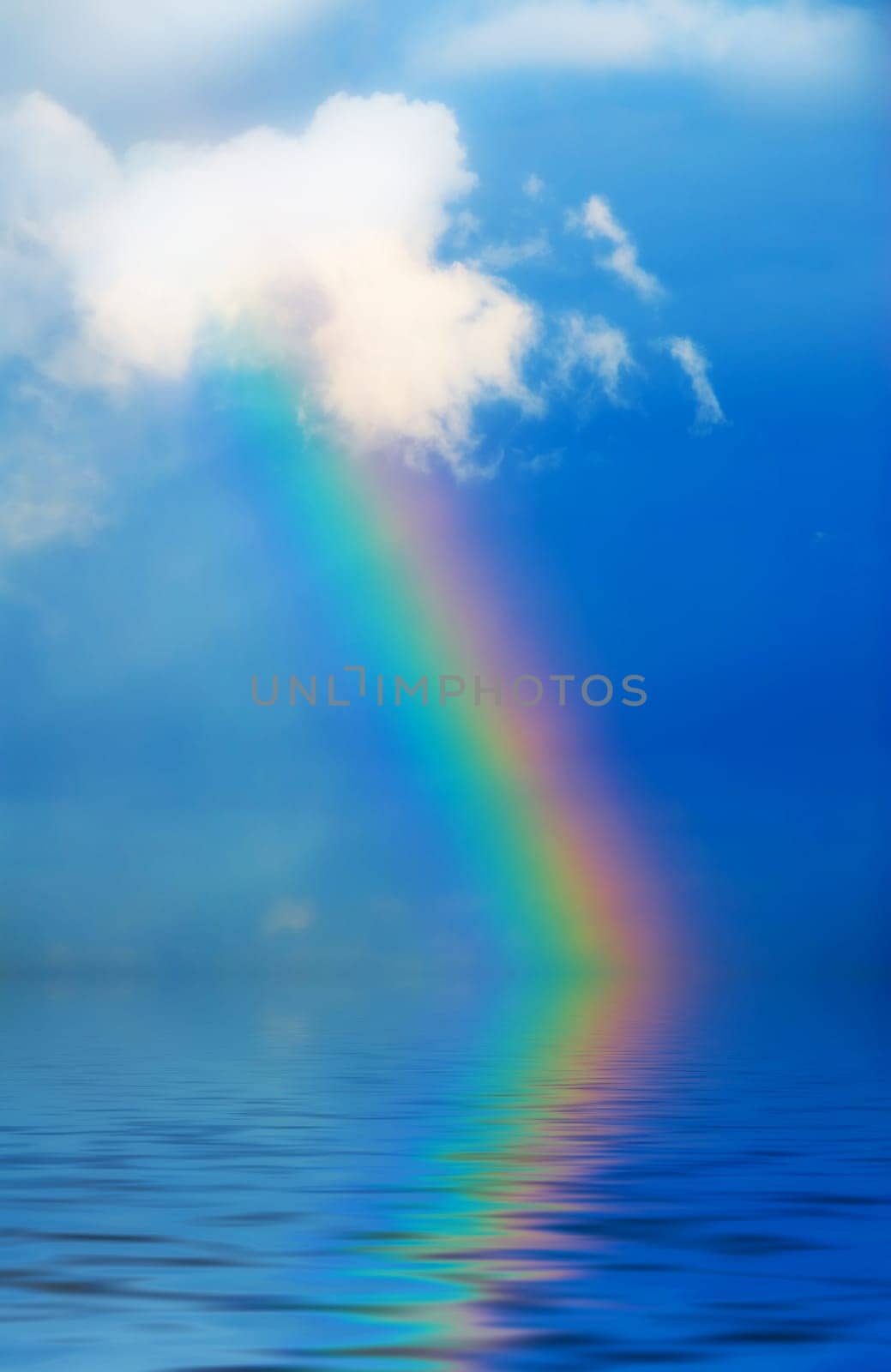 rainbow in the sky during rain on blue