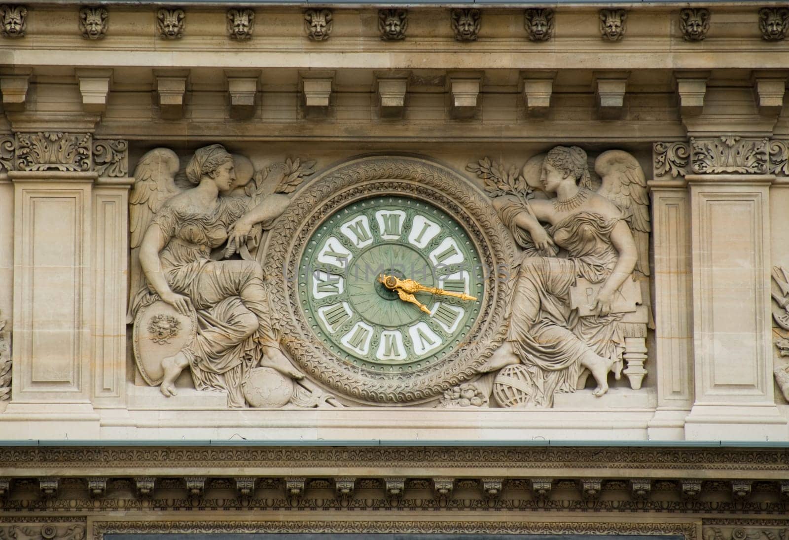 this is an antique clock in a building face