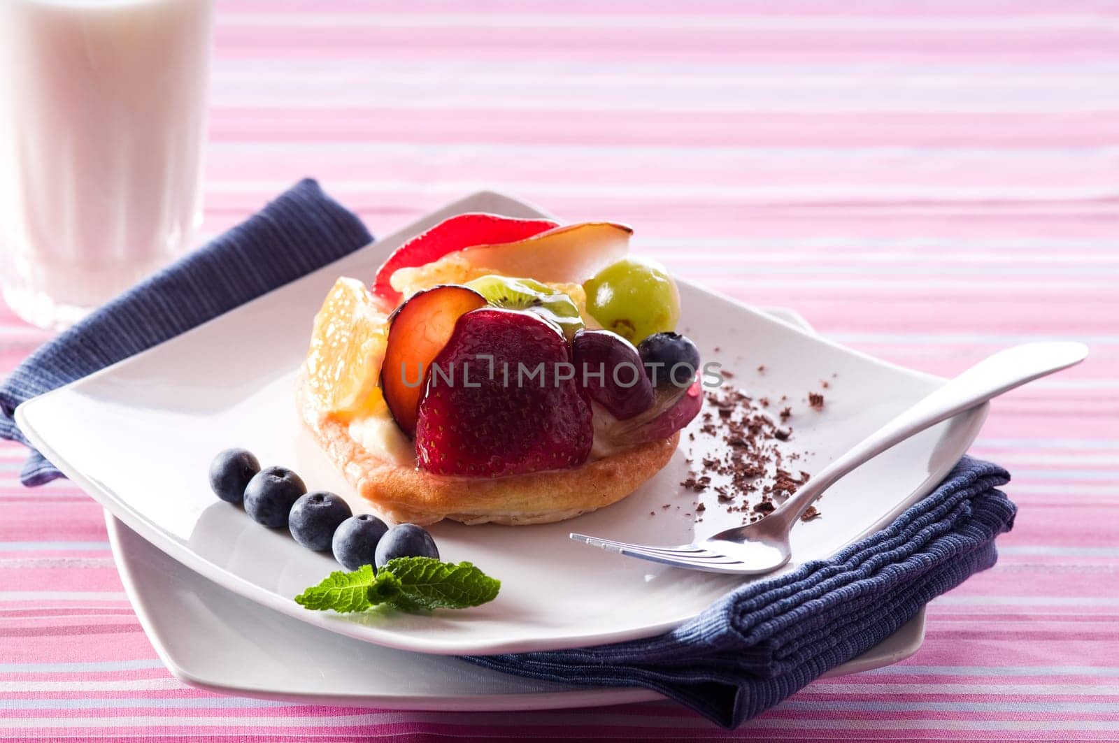 Fruit Tart on a white plate on a table