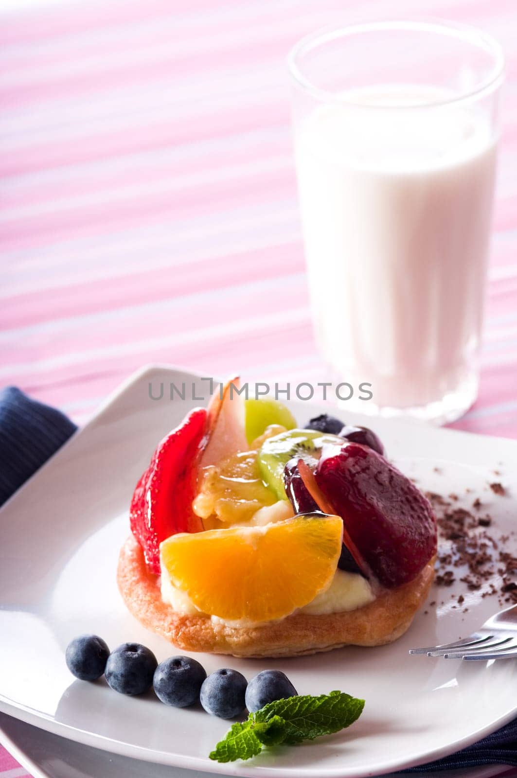 Fruit Tart on a white plate on a table