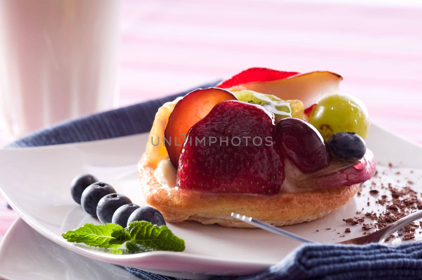 Fruit Tart on a white plate on a table