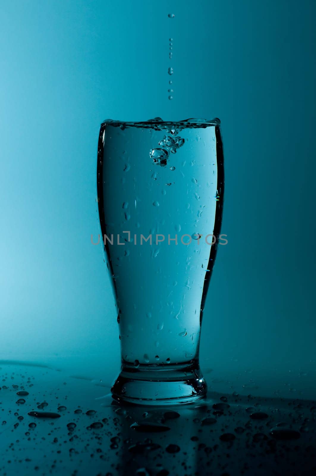 glass of pure water in a blue tone