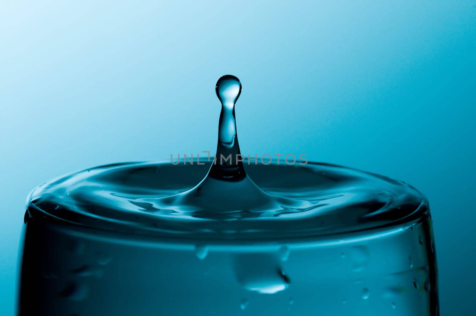 glass of pure water in a blue tone