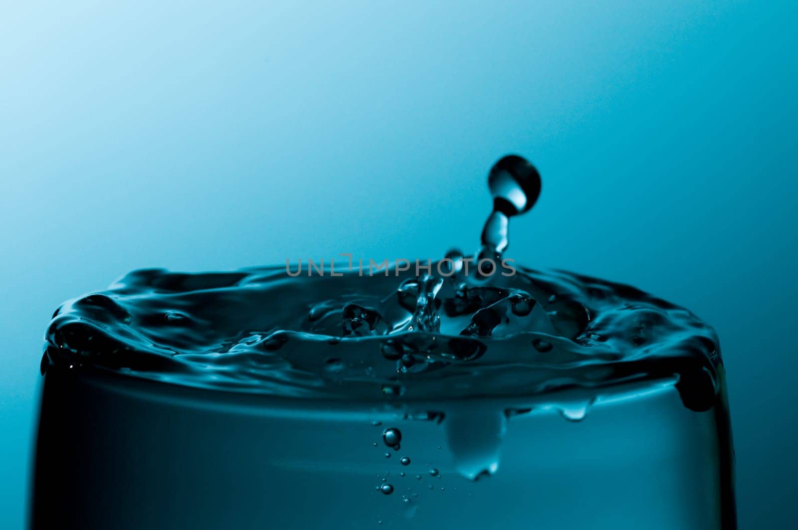glass of pure water in a blue tone