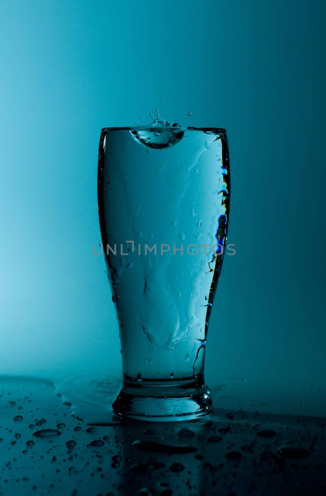 glass of pure water in a blue tone