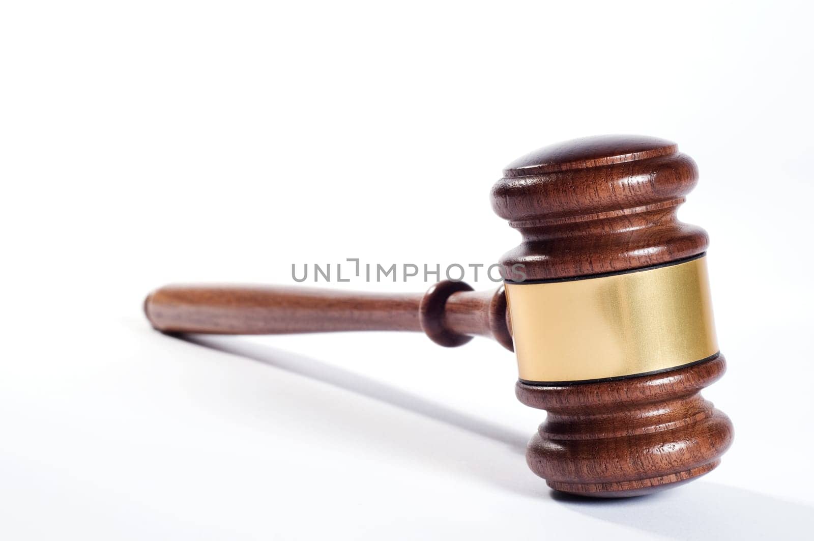 Wooden justice gavel and block with brass