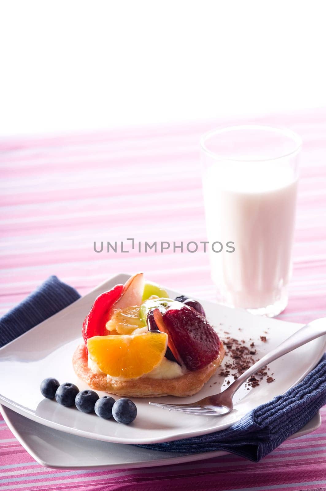 Fruit Tart on a white plate on a table